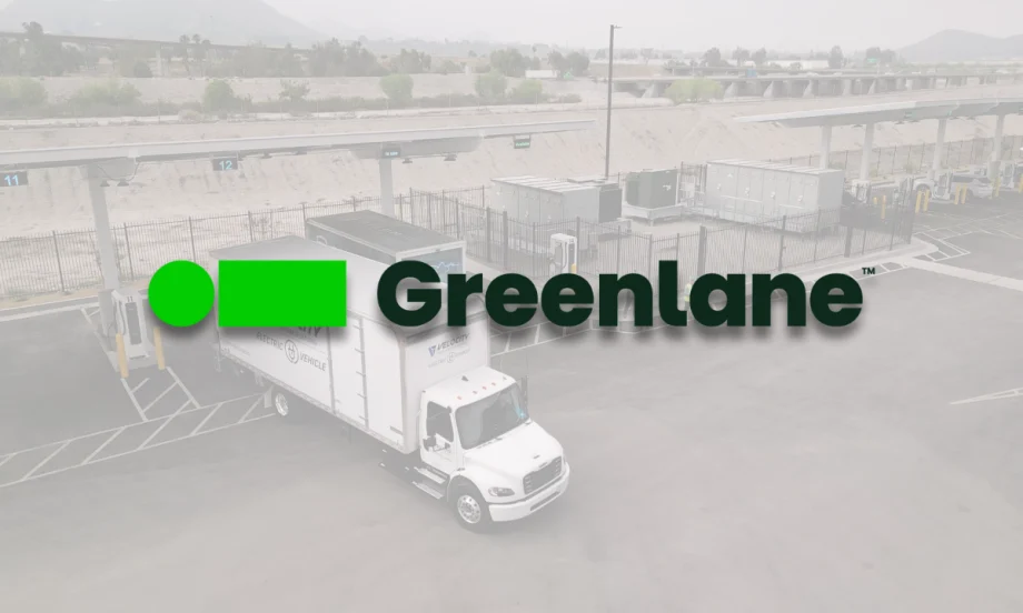 Greenlane logo overlaid on a picture of a Velocity electric truck parked at Greenlane’s Colton, California charging site with multiple charging stations visible.