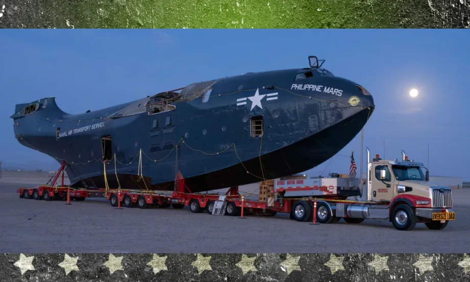Western Star 49X truck towing the massive Philippine Mars flying boat at night under a full moon during its move to the Pima Air & Space Museum.