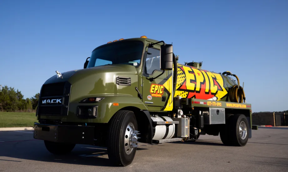 Army green septic tanker truck with yellow Epic logo on the side.