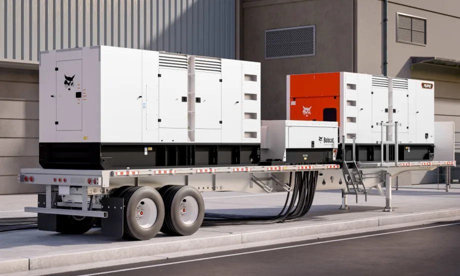 Side view of a flatbed trailer with two large mobile generators.
