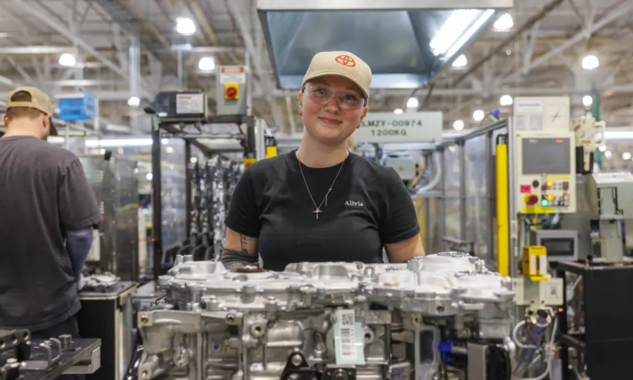 Toyota manufacturing employee assembling hybrid powertrain components on the factory floor as part of the company’s expanded U.S. hybrid production investment.