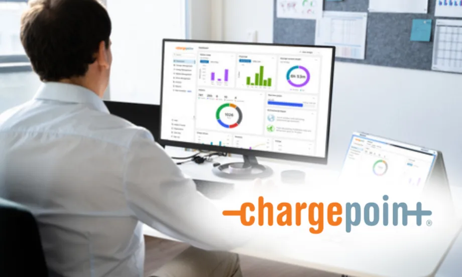 Person at a desk viewing a computer monitor with ChargePoint analytics dashboards; ChargePoint logo appears on the image.