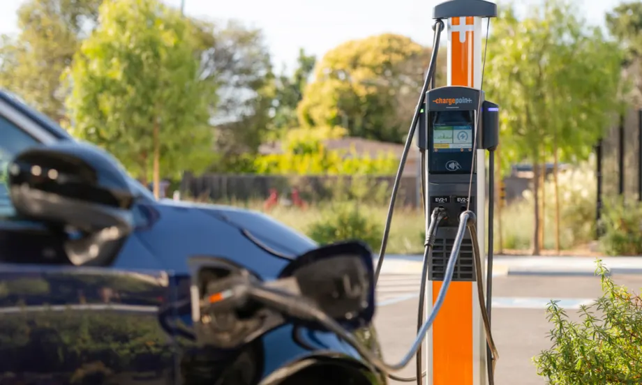 Electric vehicle connected to a ChargePoint charging station outdoors, illustrating campus EV charging infrastructure.