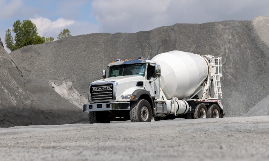 White concrete truck driving off road.