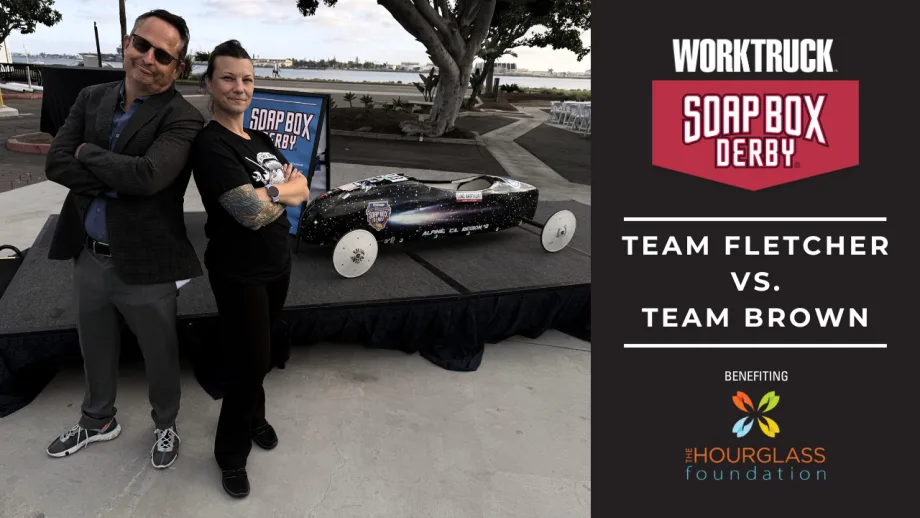 Lauren Fletcher and Chris Brown stand beside a soap box derby car ahead of the 2026 Corporate Soap Box Derby Challenge, where Team Fletcher will race to support skilled trades scholarships.
