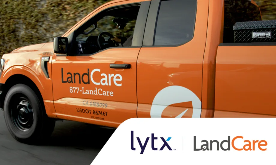 Side view closeup of an orange pickup truck with lettering for LandCare and at bottom right inset logos for Lytx and LandCare.