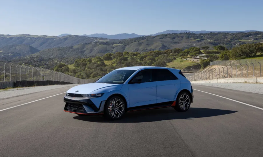 Blue 2026 Hyundai IONIQ 5 N performance electric hatchback parked on a racetrack with mountains in the background.