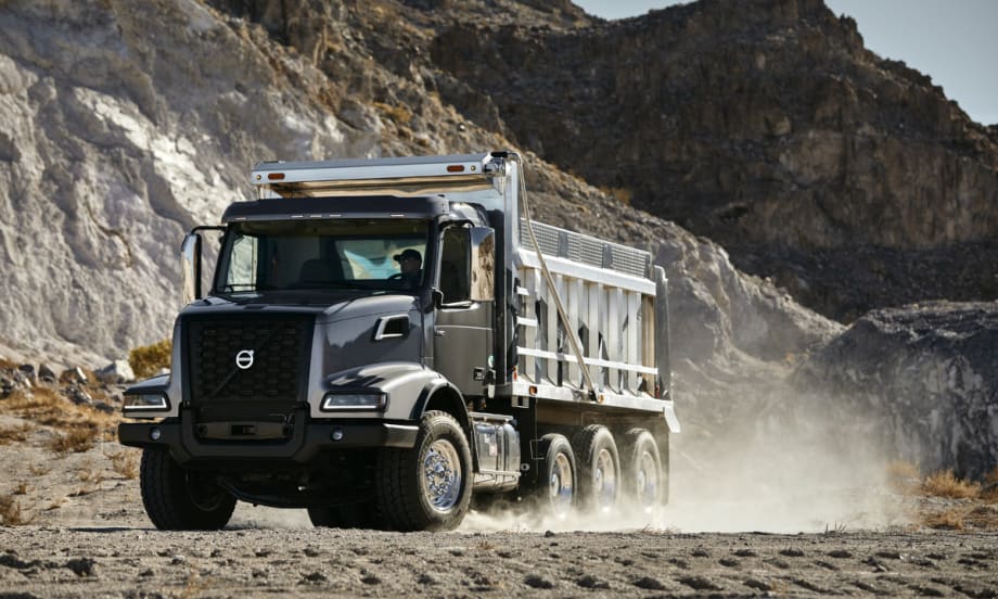 Dump truck driving across dirt.