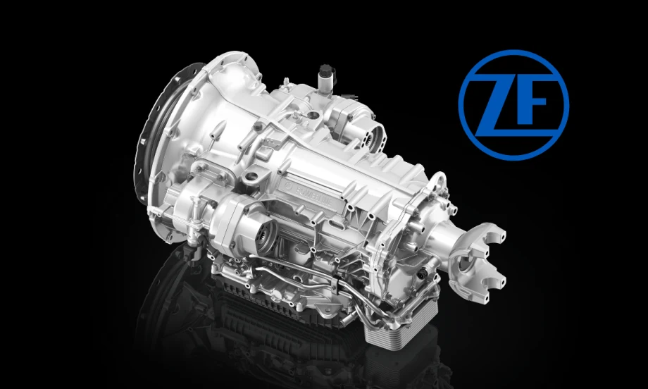 Silver truck transmission against a black background and a blue ZF logo.