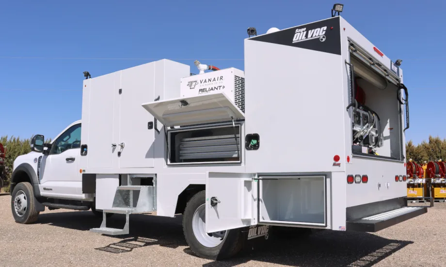 Rear-quarter view of a white work truck with storage doors open.