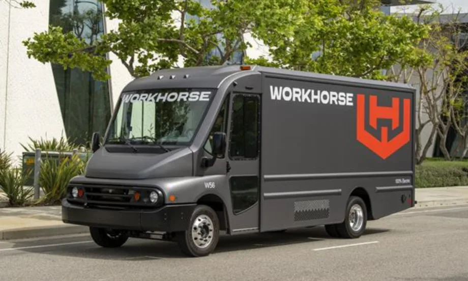 side view of a gray step van with a Workhorse logo parked in a paved parking lot.