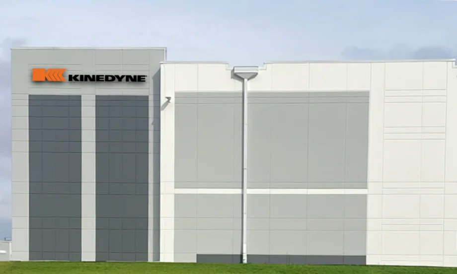 Artist's rendering of a white industrial building with Kinedyne logo.