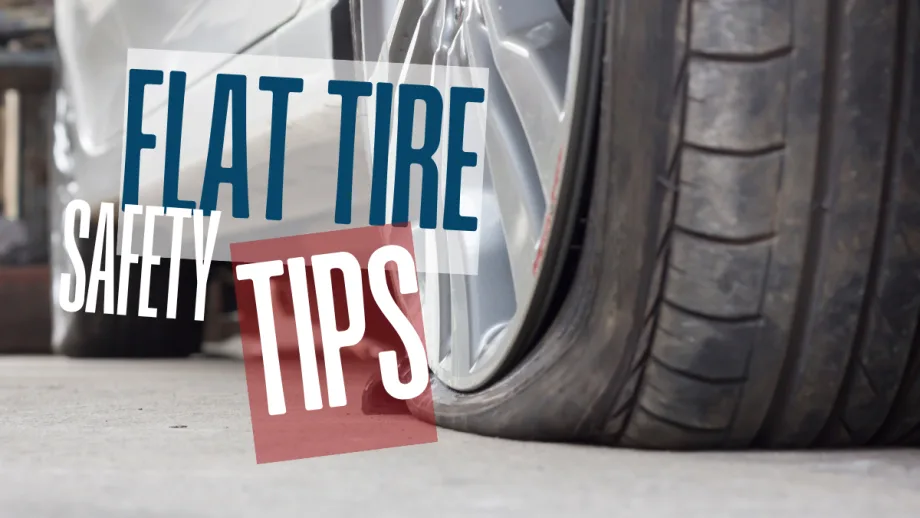 Close-up of a flat car tire on the roadside, illustrating the importance of safe handling and proper response during a tire emergency.