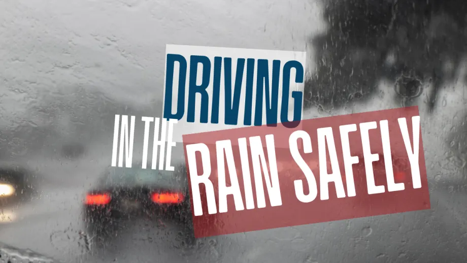 View through a rain-covered windshield with blurred brake lights ahead, illustrating reduced visibility and the need for cautious driving in wet conditions.
