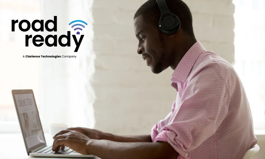side view of a man working on a laptop computer with upper left logo for Road Ready.
