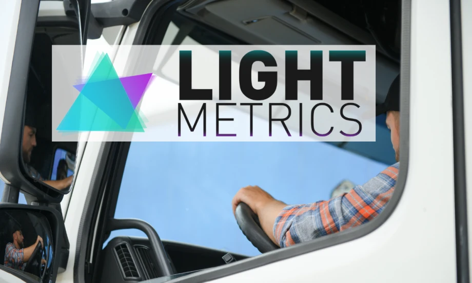 Side view of a man in a truck cab with overlay of logo for LightMetrics.