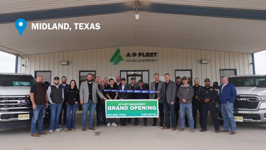 AP Fleet Management team members and local guests pose during a ribbon cutting ceremony outside the company’s new Midland, Texas, fleet facility alongside commercial pickup trucks.