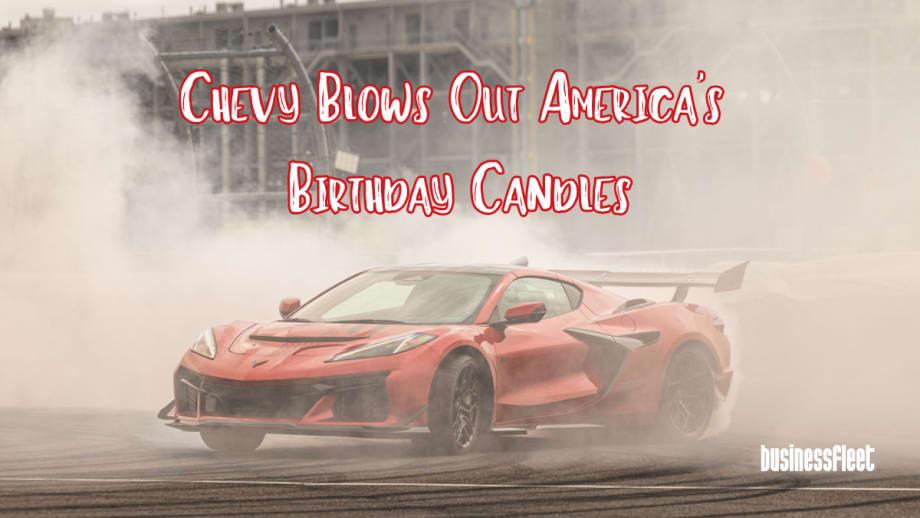 A red Chevrolet Corvette performs a burnout surrounded by smoke at Indianapolis Motor Speedway with text overlay reading “Chevy Blows Out America’s Birthday Candles” and Business Fleet branding in the corner.