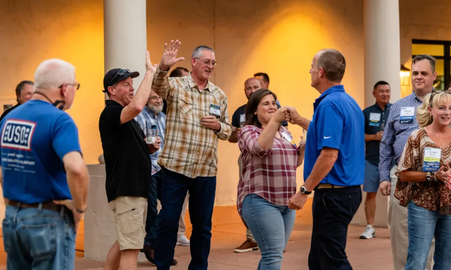 Fleet managers and supplier partners interact during a Work Truck Exchange networking event featuring games and attendee activities.