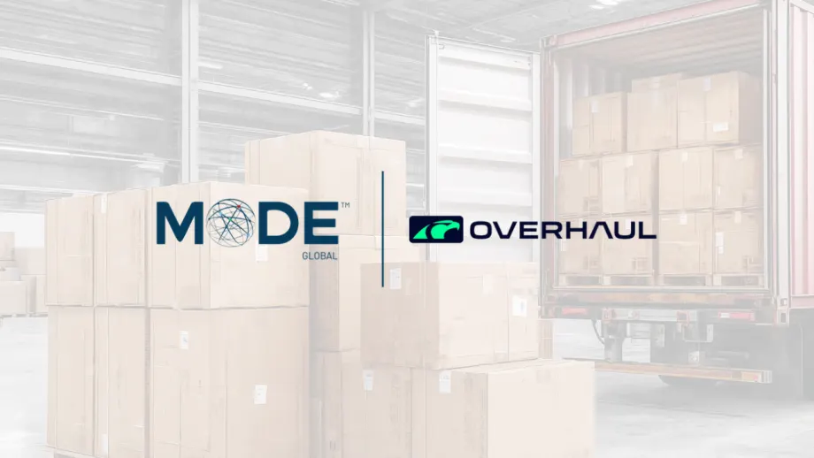 MODE Global and Overhaul logos displayed over a warehouse scene with stacked shipping boxes and a loaded trailer, illustrating a logistics technology partnership focused on freight visibility and supply chain operations.
