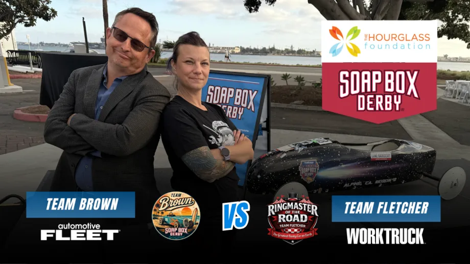 Chris Brown of Automotive Fleet and Lauren Fletcher of Work Truck pose beside a Soap Box Derby car in a Team Brown vs. Team Fletcher race graphic benefiting The Hourglass Foundation.
