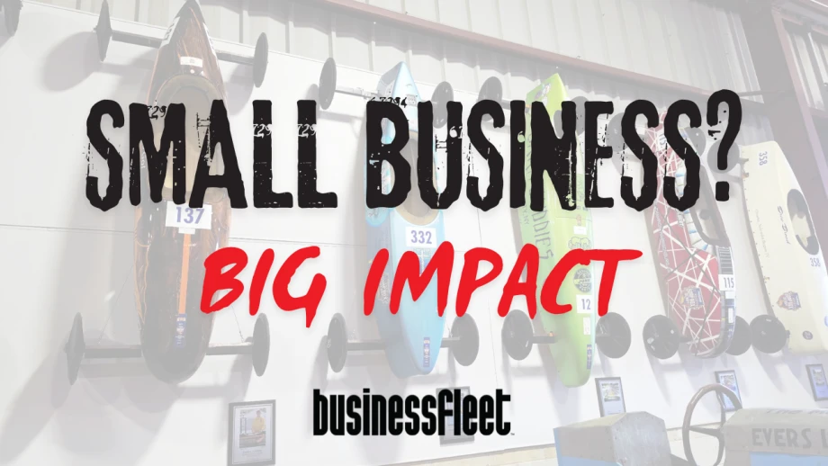 Vintage and modern Soap Box Derby cars displayed on a wall behind the words “Small Business? Big Impact” and the Business Fleet logo.