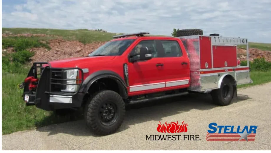 Red Midwest Fire service truck equipped with a Stellar body parked along a rural road, with Midwest Fire and Stellar logos displayed at the bottom.