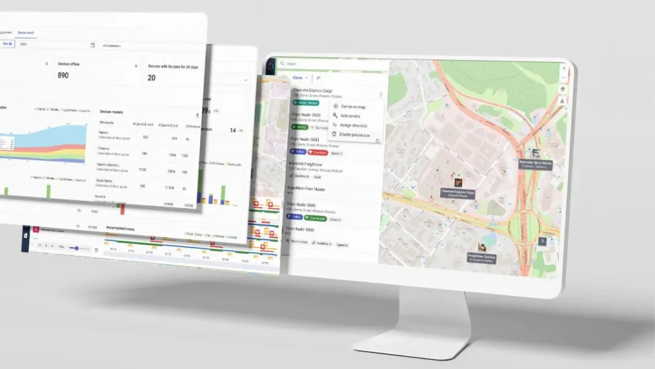 Fleet management software displayed on a computer monitor, showing vehicle tracking maps, device status, fleet analytics, charts, and operational data dashboards.