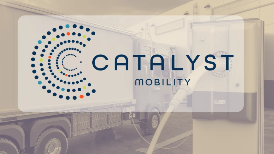 Catalyst Mobility logo displayed over an image of an electric commercial truck connected to a charging station inside a facility.