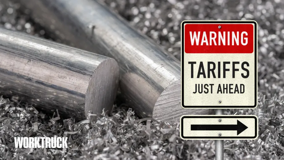 Aluminum billets and shavings beside a warning sign reading “Tariffs Just Ahead.”