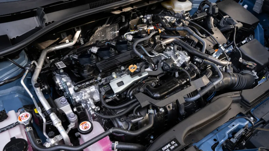 Engine compartment of a 2027 Toyota Corolla Cross Hybrid showing components of its hybrid powertrain.