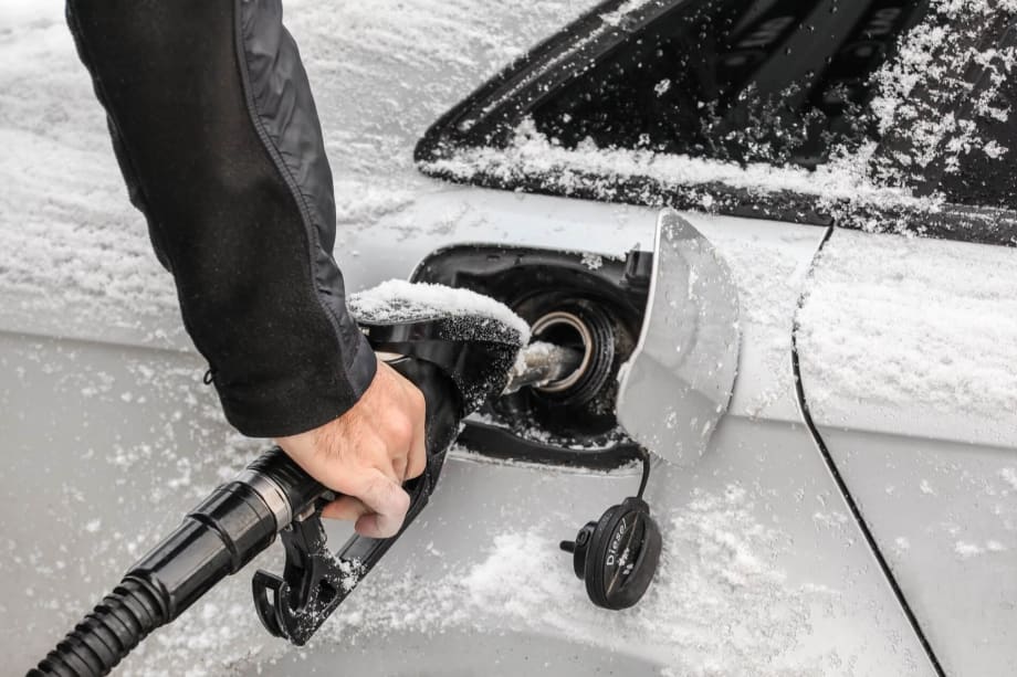 Fuel getting pump into a white car