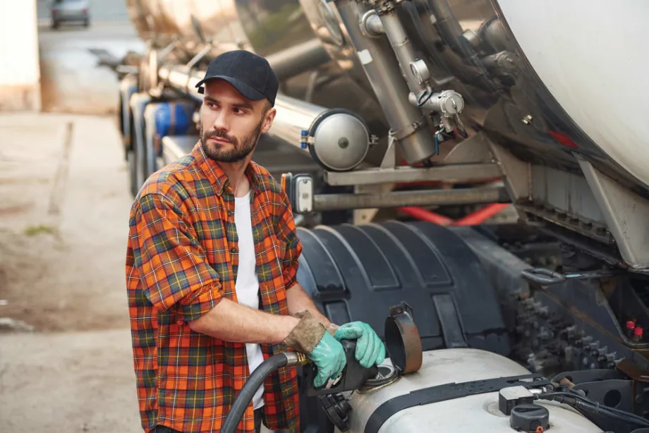 A person refueling his truck