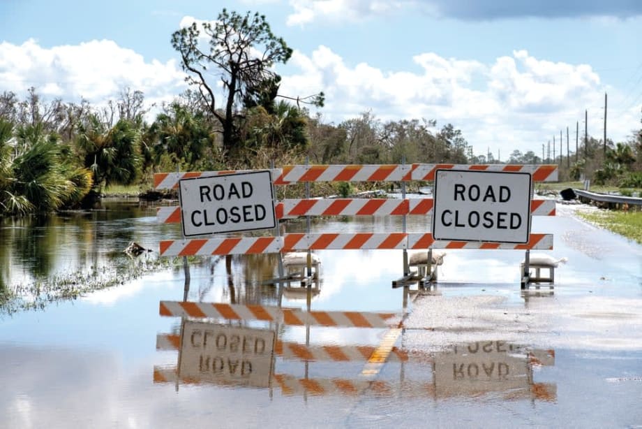 semi flooded road with sign Road closed