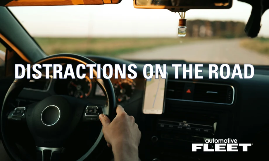 A person with hands on the steering wheel driving