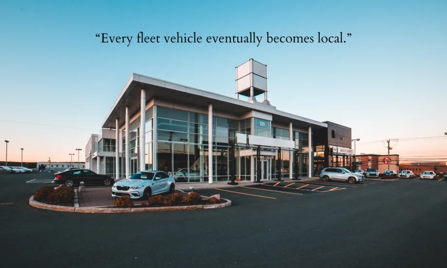 A car dealership with added inscription "Every fleet vehicle eventually becomes local."