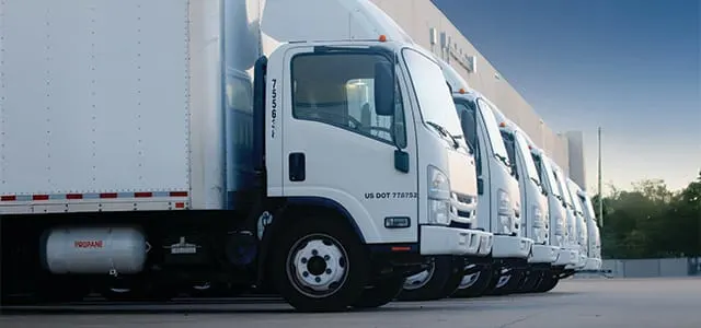 A line-up of white medium-duty trucks