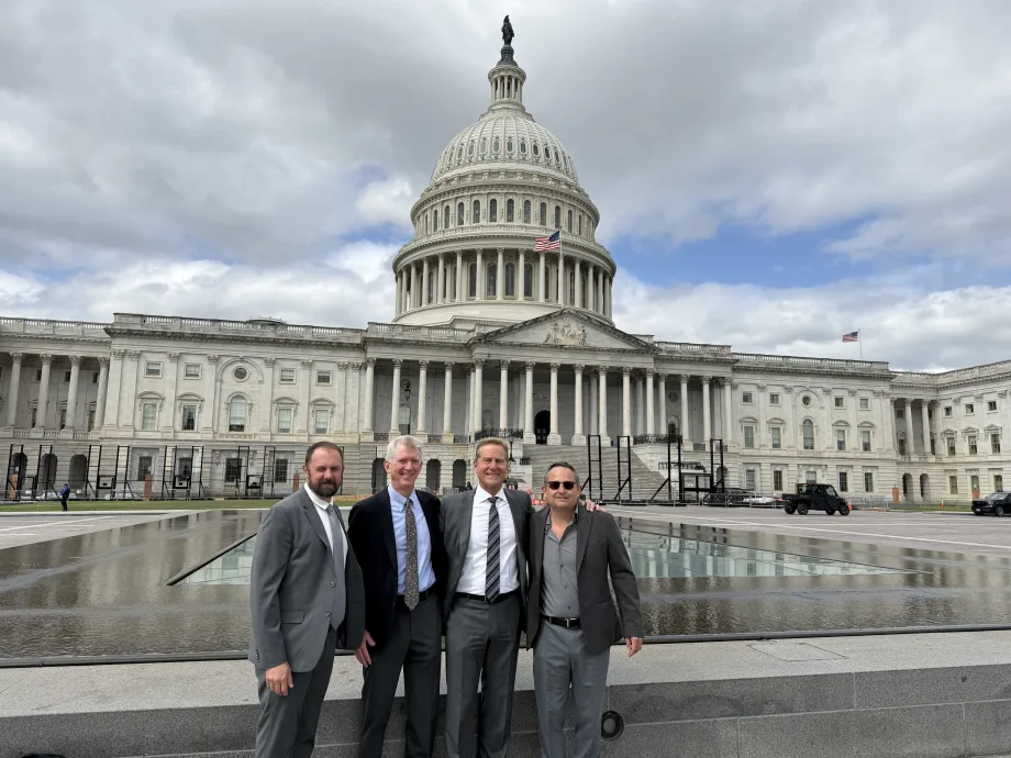 Four ACRA members stand in front of U.S. Capitol