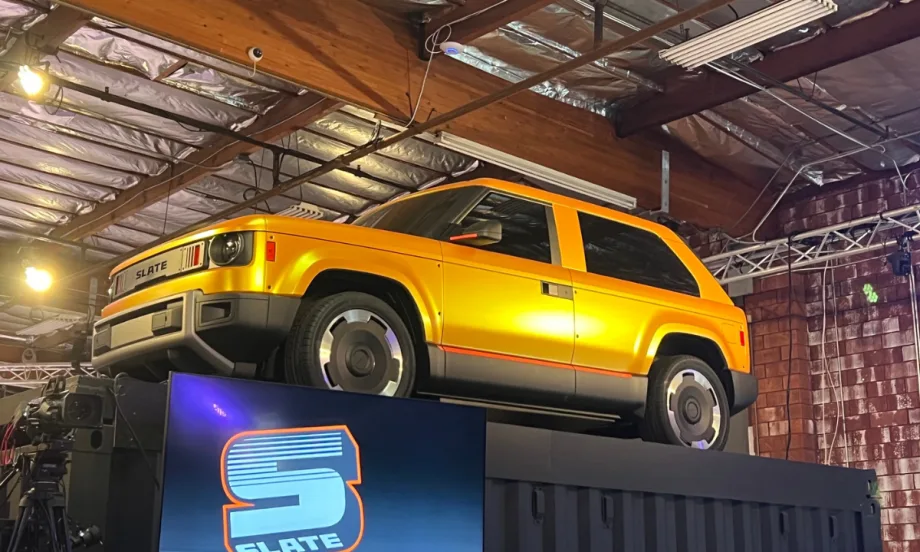 Yellow Slate Fastback on a raised platform in a warehouse.