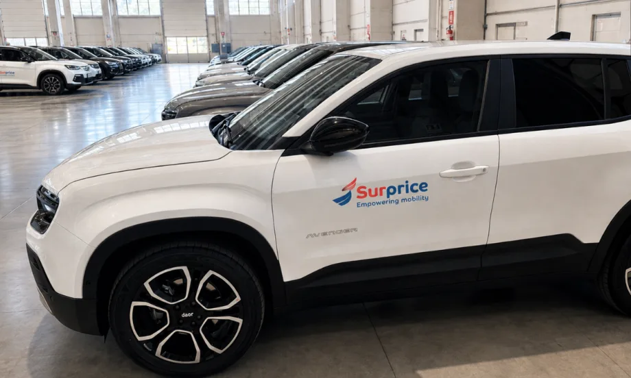 Close up of a row of white CUVs in the Surprice Mobility fleet at the Milan airport.