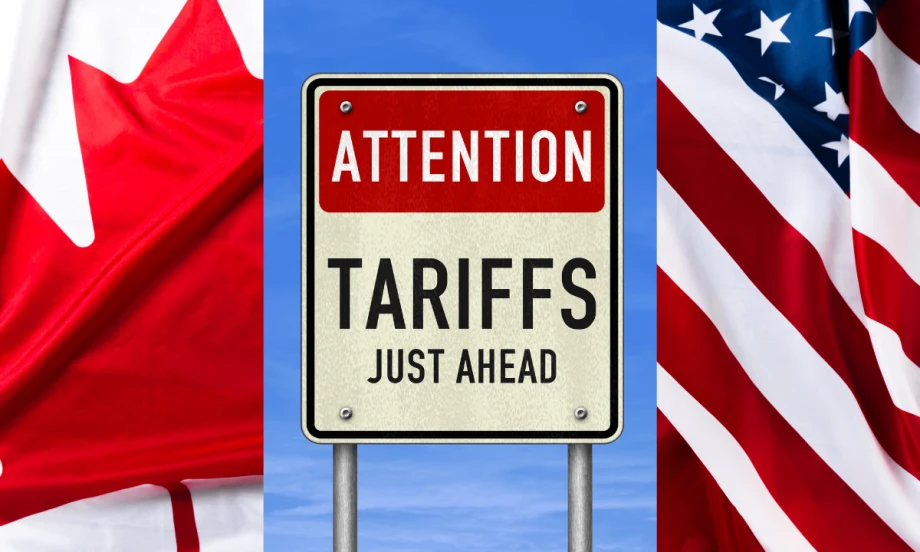 U.S. and Canadian flags and sign that says tariffs ahead