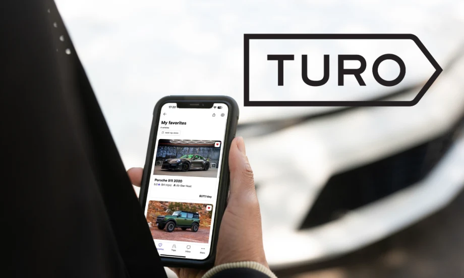 hand holding phone and Turo logo