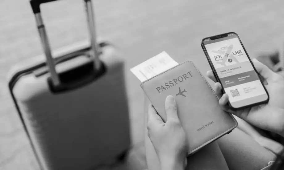 Photo of a suitcase, passport, and smartphone.