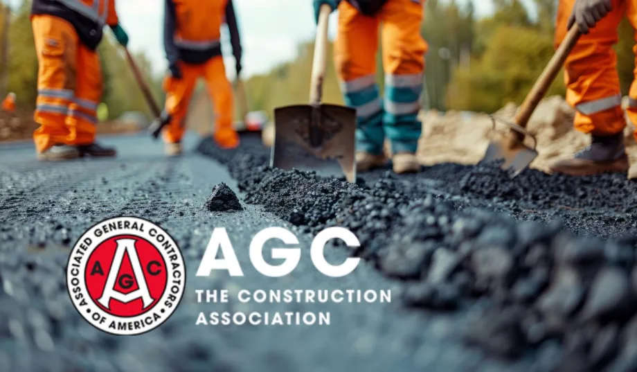 Construction workers are laying asphalt on the road.