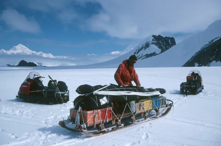 Explorer in Arctic packs sled.