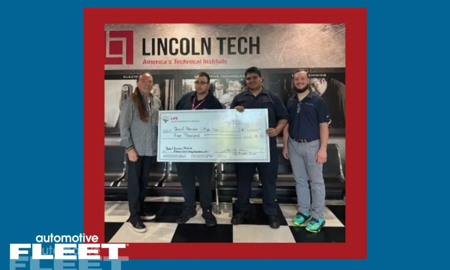 Four individuals stand holding a check honoring two students who won scholarships money at Lincoln Tech.