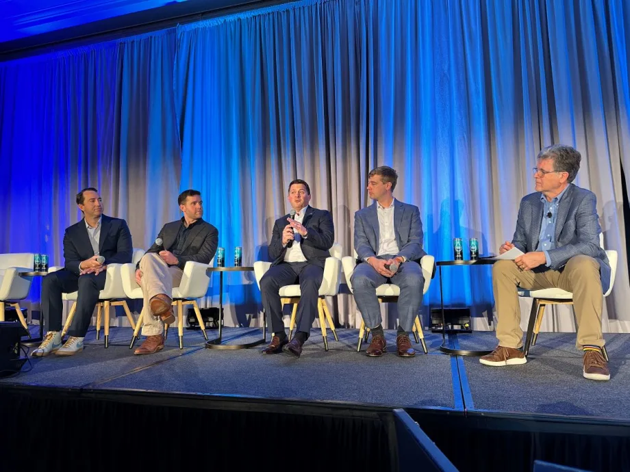 Five seminar panelists sit on stage.