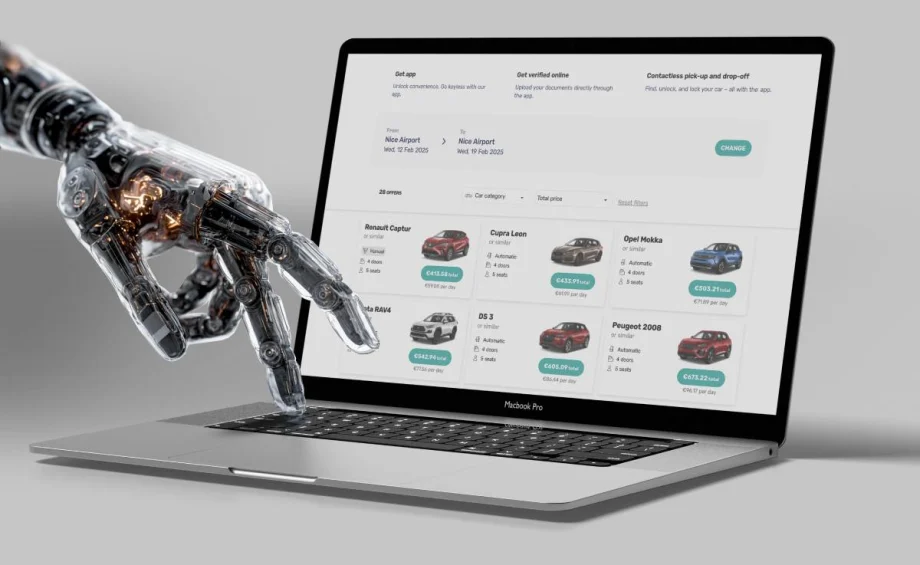 A robotic hand searching for a rental car on a laptop computer.