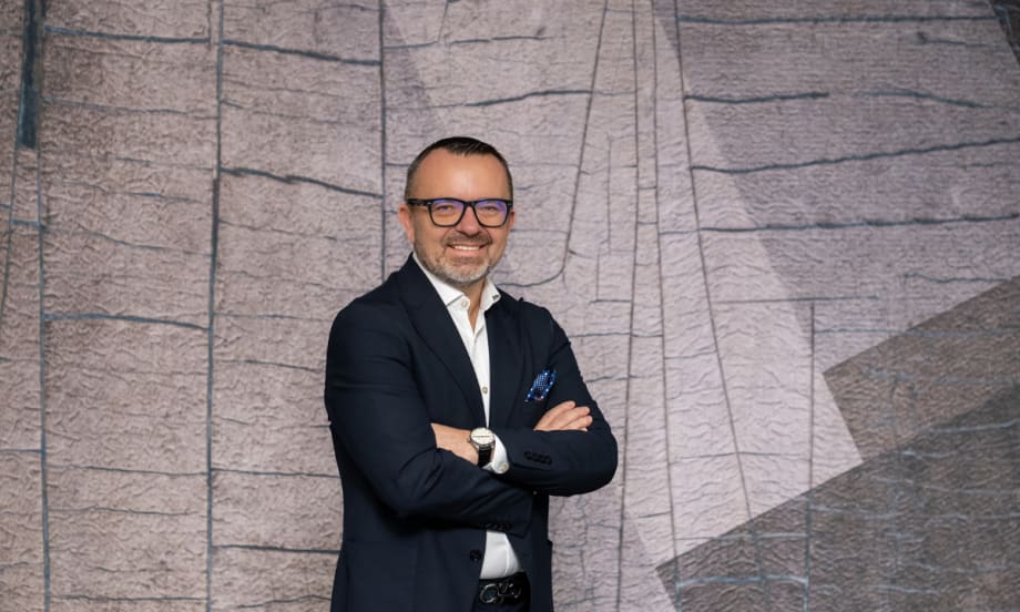 Photo of CEO Krešimir Dobrilović against a gray modernist crooked-tile mural display.