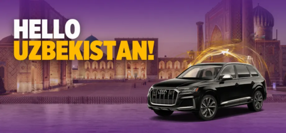 A black Audi SUV superimposed on a historic scene from downtown Tashkent, Uzbekistan.